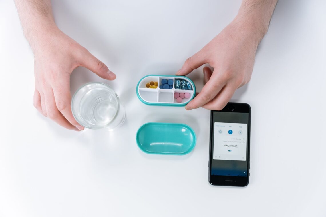 person holding pill box