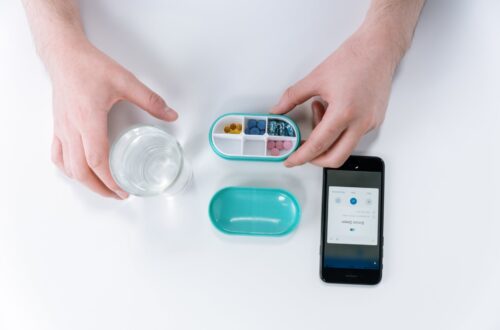 person holding pill box